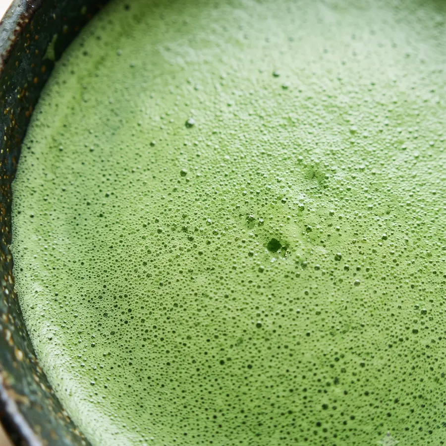 Freshly whisked matcha foam, close